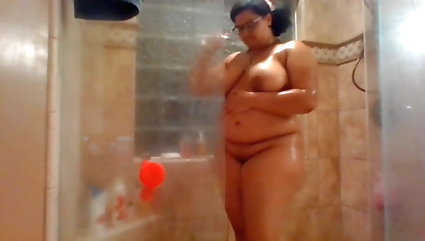 Ebony milf with a huge booty plays with her toy in a shower