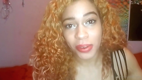 Red head with a red dress and a red shoe in a solo video