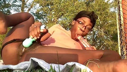 Ebony hottie with a hairy pussy enjoying outdoor toy