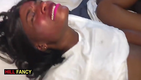 Ebony brunette and her black masseuse on a couch in a threesome